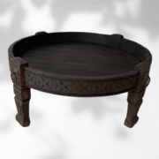 Round wooden coffee table handcrafted in Morocco from cedar with carved design