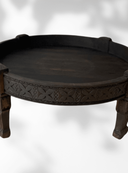 Round wooden coffee table handcrafted in Morocco from cedar with carved design
