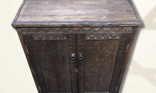Moroccan entryway cabinet with carved wood details and natural finish